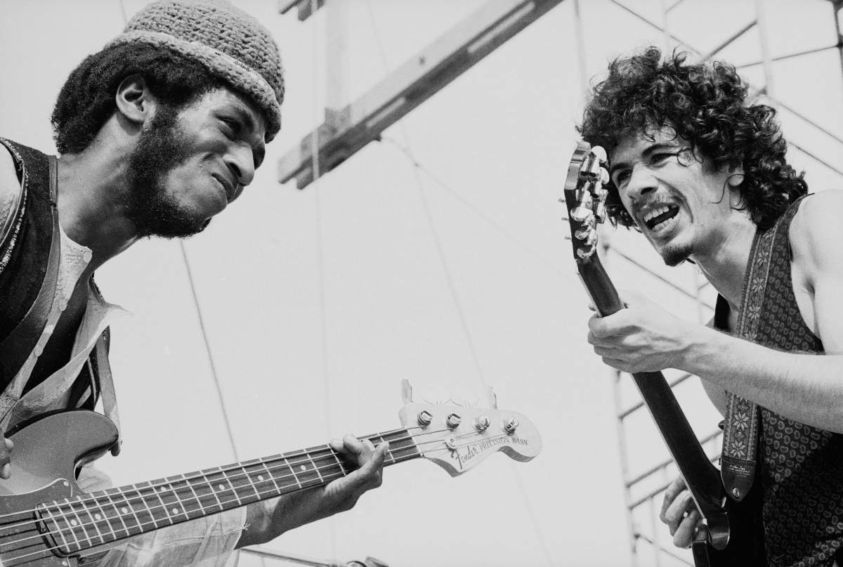 Carlos Santana (R) and David Brown perform with the other members of Santana at Woodstock in Bethel Woods, N.Y., on Aug. 16, 1969.