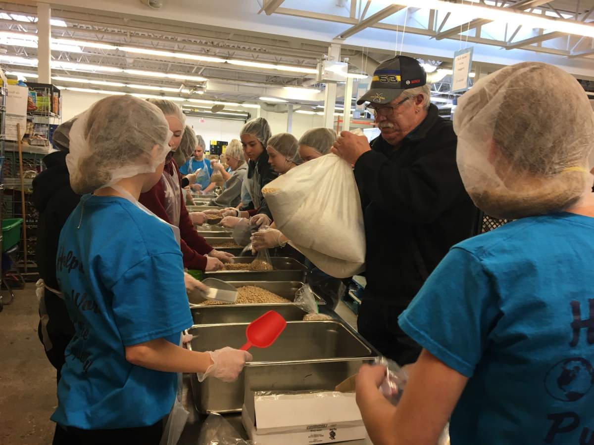 Students sort through beans at Winnipeg Harvest.