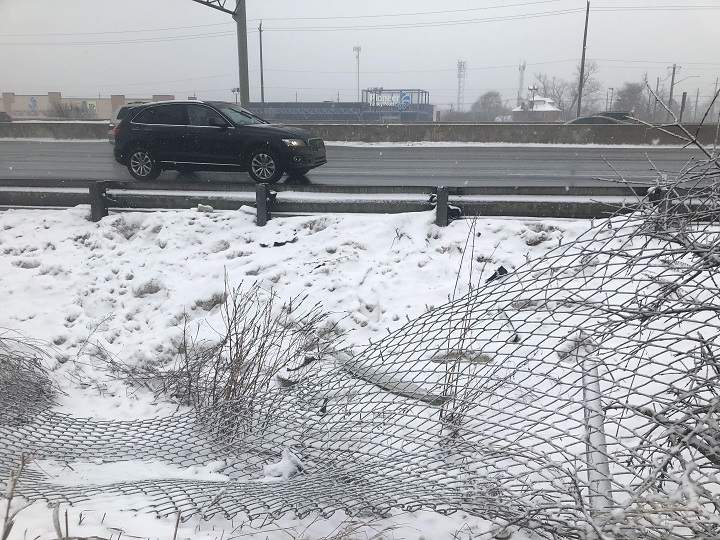 It is believed the car smashed through this fence and went onto the highway.