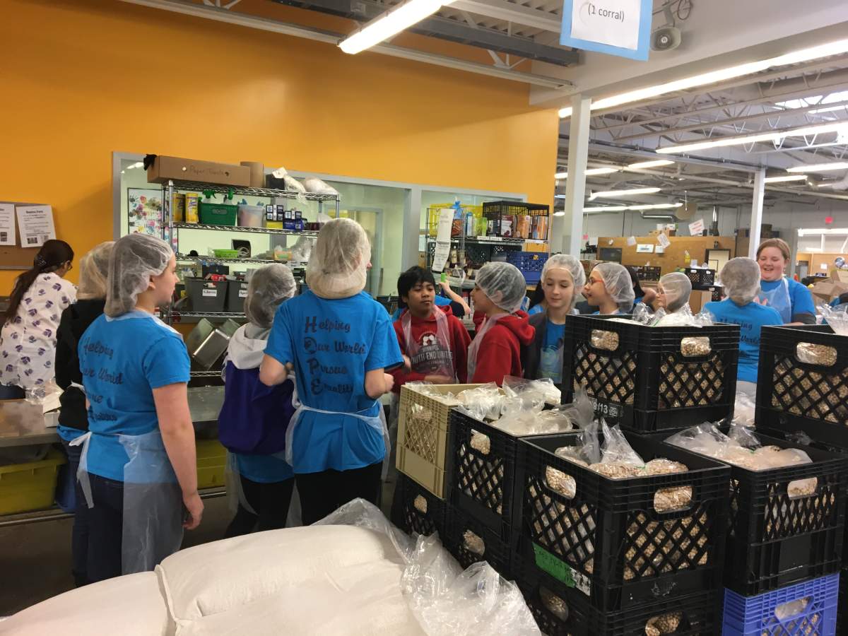 Students packaging beans at Winnipeg Harvest.