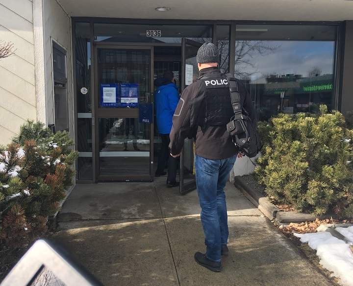 A police officer stands outside a Royal Bank branch in Kelowna after it was robbed on Friday morning.