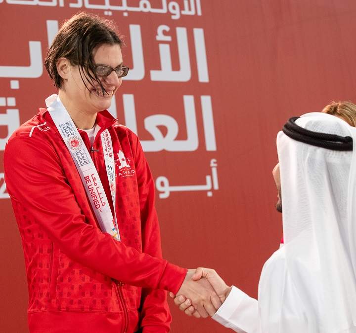 Kelsey Wyse of Kelowna shakes hands with a dignitary at the Special Olympics World Games.