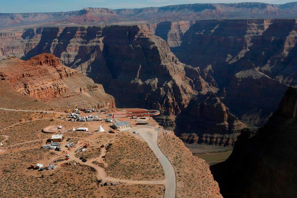 In this March 20, 2007, file photo, the Skywalk hangs over the Grand Canyon on the Hualapai Indian Reservation before its grand opening ceremony at Grand Canyon West, Ariz. Crews are searching for a tourist who slipped and fell over the edge of a Grand Canyon lookout on tribal land. The fall happened Thursday, March 28, 2019, morning on the Hualapai Tribe's reservation outside the boundaries of Grand Canyon National Park.