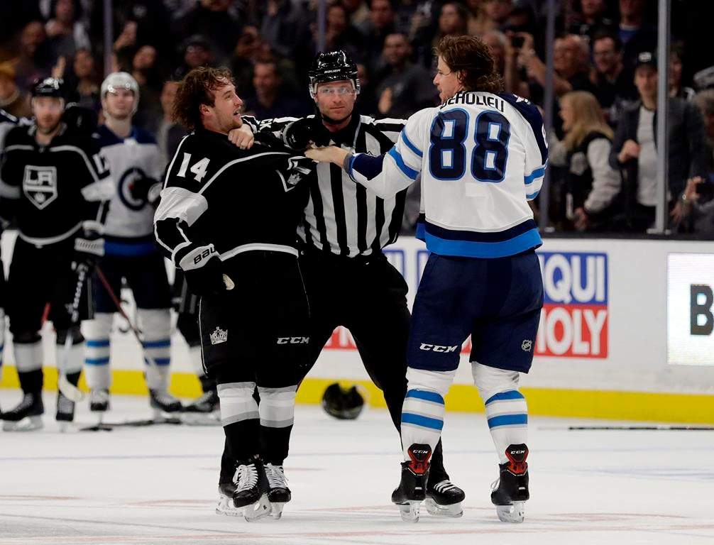 The Los Angeles Kings’ Brendan Leipsic, left, and Winnipeg Jets’ Nathan Beaulieu (88) are separated by a referee during the second period of an NHL hockey game Monday, March 18, 2019, in Los Angeles. (AP Photo/Marcio Jose Sanchez)