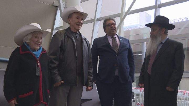 Marthe and Major L. Cohn are presented with white hats by Mayor Naheed Nenshi on Sunday in Calgary.