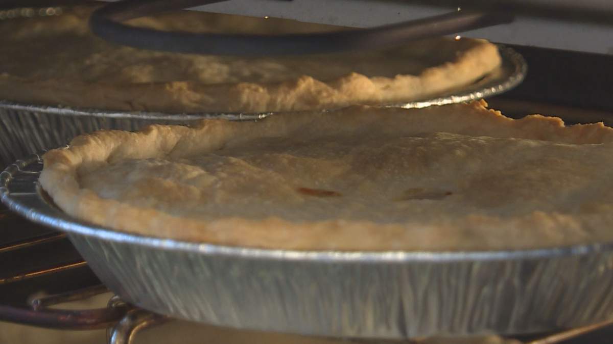 A hot meat pie cooks in the oven.