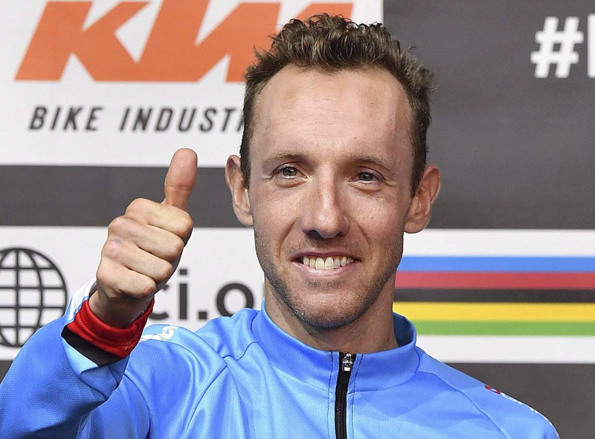 Third place winner Michael Woods, of Canada, gives a thumbs up after the men's road race at the Road Cycling World Championships in Innsbruck, Austria, Sunday, Sept. 30, 2018.