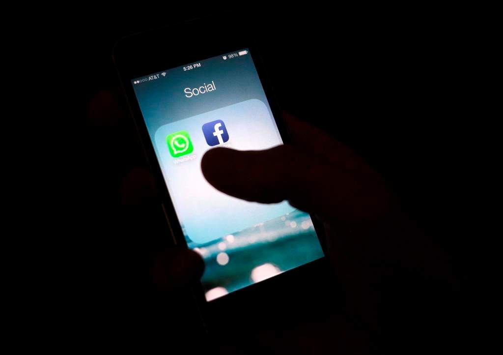 This Feb. 19, 2014, file photo shows the Facebook app icon on an iPhone in New York.