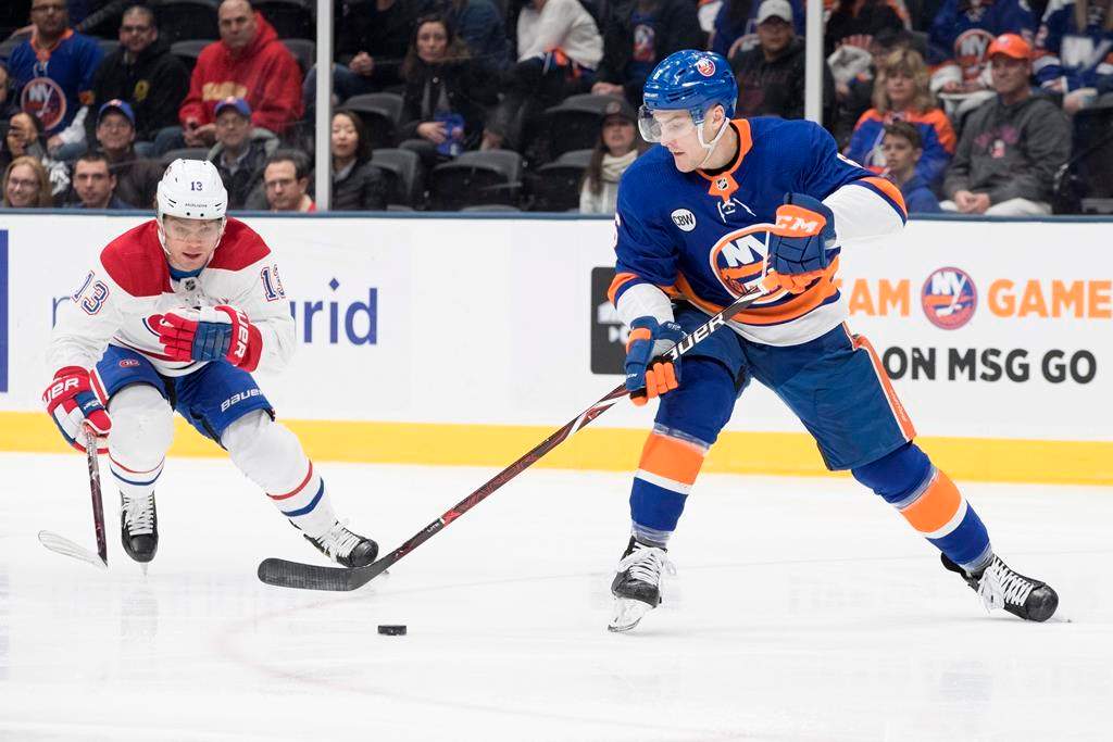 New York Islanders defenseman Ryan Pulock (6) skates against Montreal Canadiens center Max Domi (13) during the first period of an NHL hockey game, Thursday, March 14, 2019, in Uniondale, N.Y.