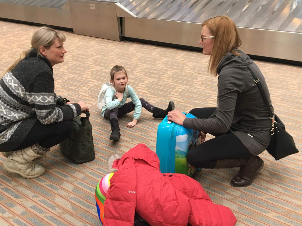 Krista Hobbs with her daughter after landing in Winnipeg