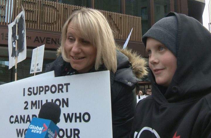 Whitecap Resources employee Renee Pozzo and her son Maxwell Pozzo protest in support of pipelines in Calgary on Monday.
