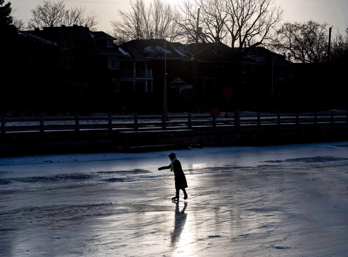 People skate under the Queen Elizabeth Driveway to Paterson Creek on the Rideau Canal Skateway on its opening day, in Ottawa on Sunday, Dec. 30, 2018. The Rideau Canal is a UNESCO World Heritage Site.