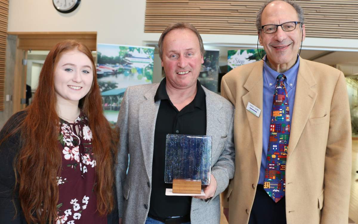 Todd Sleeper (centre) poses with his 2019 UTRCA Community Conversation Award alongside his daughter, Cassandra (left).