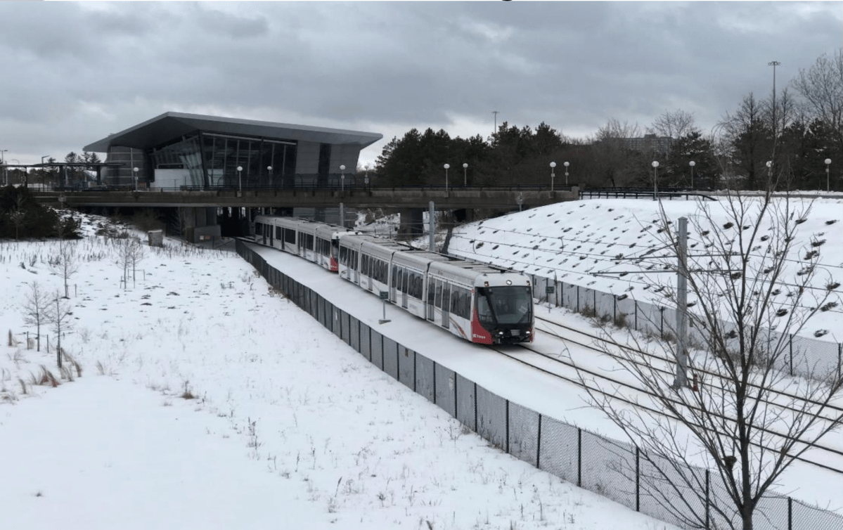 An image of an LRT train set on the tracks during the wintertime in Ottawa.