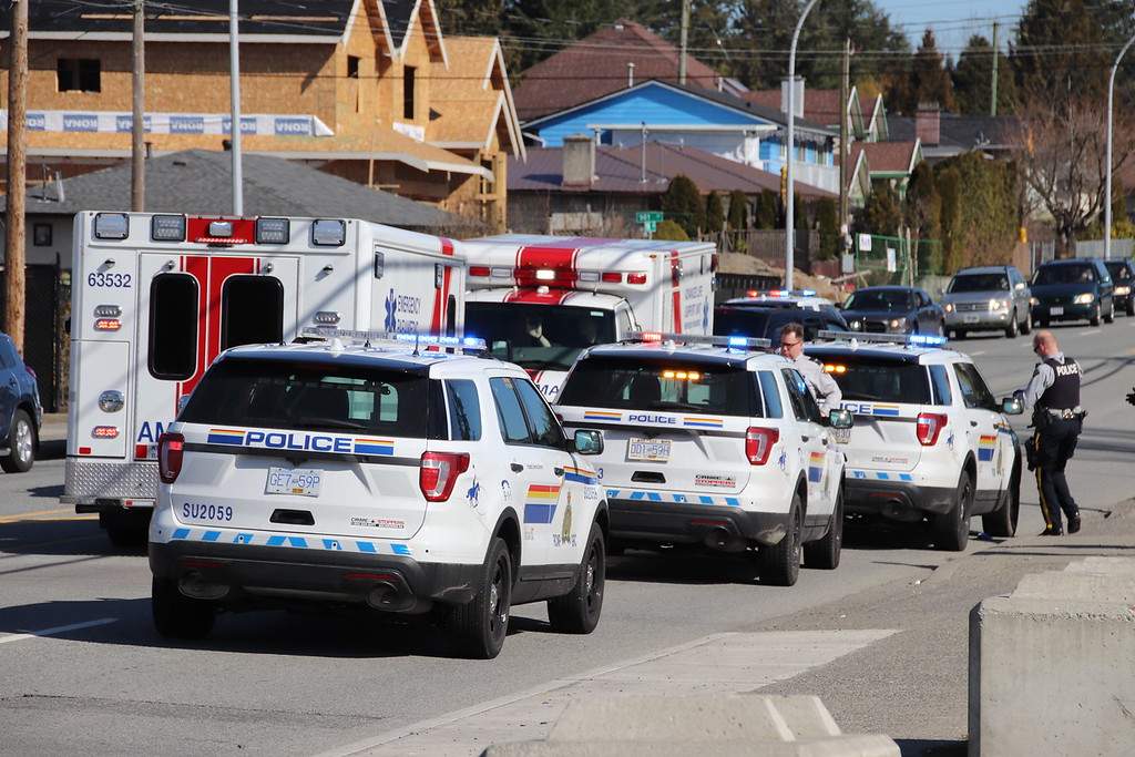 Police and paramedics outside Surrey's Hawthorne Park on Sunday. 