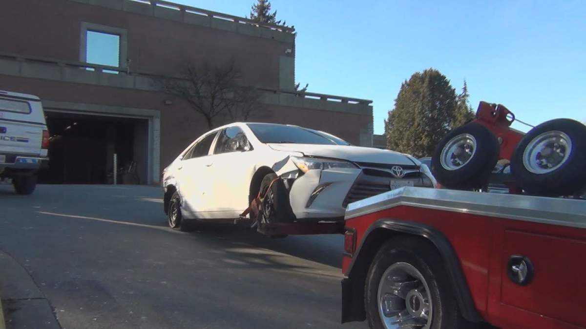 The suspect vehicle in Monday’s hit and run is towed to a police facility.