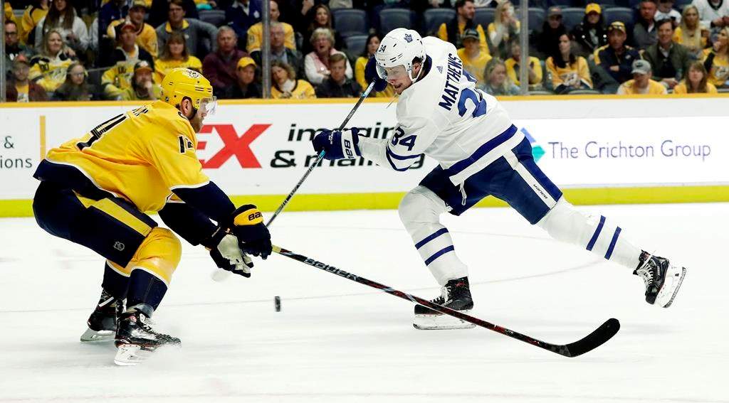 Toronto Maple Leafs center Auston Matthews (34) shoots past Nashville Predators defenseman Mattias Ekholm (14), of Sweden, in the first period of an NHL hockey game Tuesday, March 19, 2019, in Nashville, Tenn. (AP Photo/Mark Humphrey).