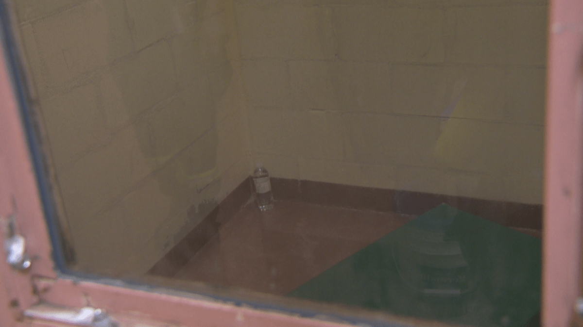 A view of one of the IPDA cells peering in through the lone window on the door.