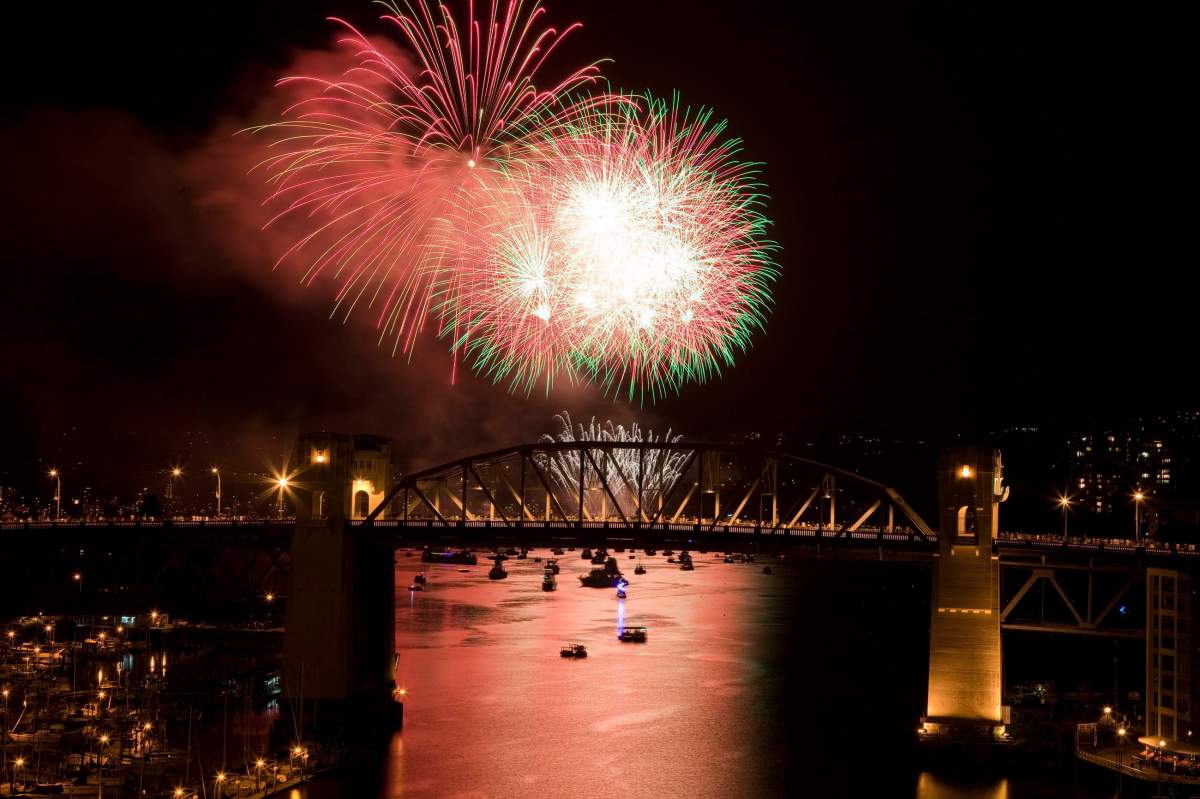 The Burrard Street Bridge is seen in the foreground as fireworks from Team China blast over the waters of English Bay during the Celebration of Light in Vancouver, Saturday, July 30, 2011.