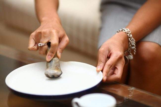 A Vietnamese woman grinds rhino horn with water in her apartment in Hanoi, Vietnam, March 13, 2012. She said she ingests the liquid after drinking too much alcohol or when suffering from allergies.