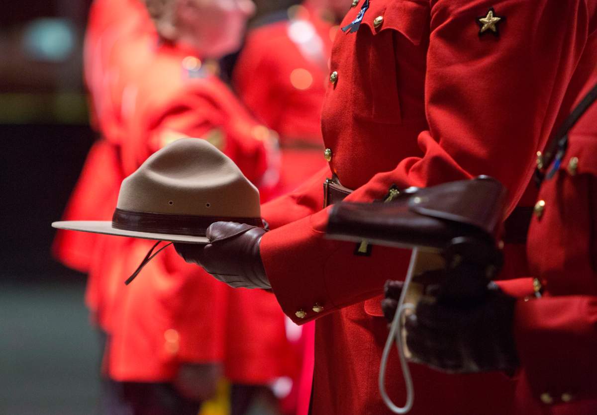 RCMP officers hold the hat and belt of slain RCMP Constable David Wynn, during his funeral in St. Albert, Alta., on Monday, January 26, 2015.