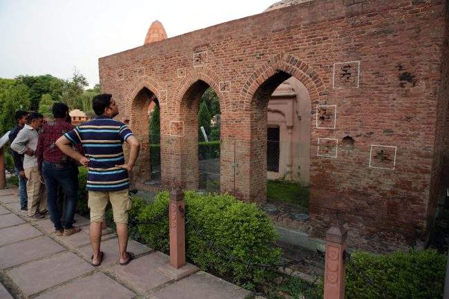 Visitors look at bullet marks from the Jallianwala Bagh Massacre at the Jallianwala Bagh Memorial in Amritsar, India, 09 August 2017.