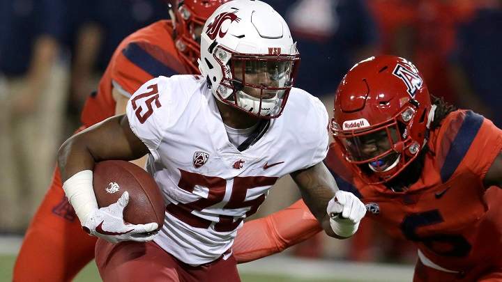Washington State running back Jamal Morrow runs a way from the tackle of Arizona safety Demetrius Flannigan-Fowles in the first half during an NCAA college football game on Oct. 28, 2017.
