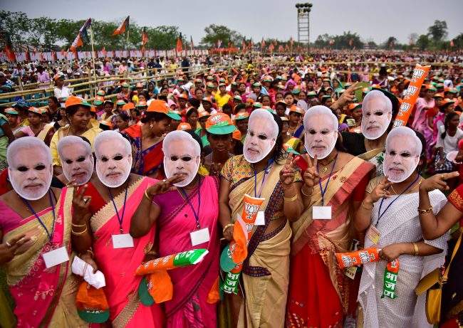 Supporter of India’s ruling Bharatiya Janata Party (BJP) wearing masks of Prime Minister Narendra Modi attend an election campaign rally addressed by Modi at Moran town in the northeastern state of Assam, India, March 30, 2019.