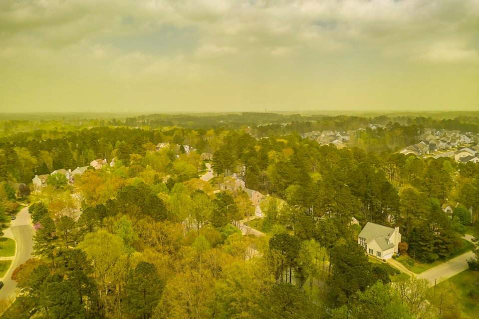 An aerial view shows pollen haze tinting the environment yellow over an area in Durham, North Carolina, U.S., April 8, 2019, in this picture obtained from social media. Jeremy Gilchrist/via REUTERS