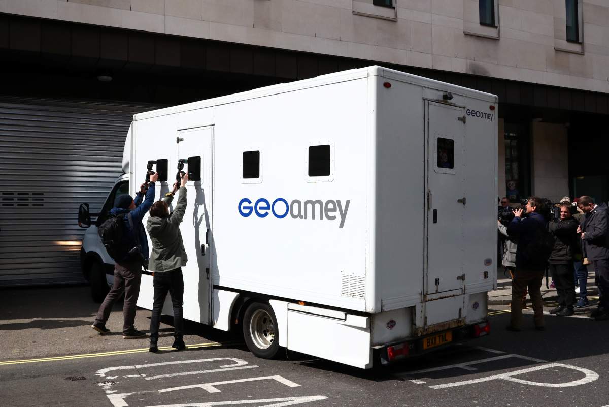 Members of the media surround a prisoner transport vehicle as it arrives at the Westminster Magistrates Court after WikiLeaks founder Julian Assange was arrested by British police outside the Ecuadorian embassy in London, Britain April 11, 2019.
