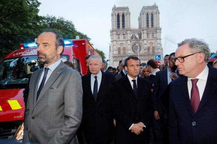 French Prime Minister Edouard Philippe, Minister of Culture Franck Riester and French President Emmanuel Macron gather near the Notre Dame Cathedral as its burns in Paris.