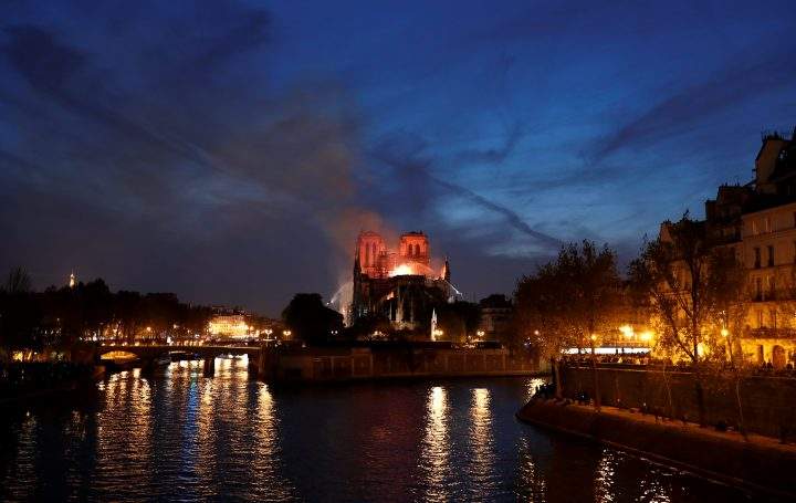 Firefighters douse flames of the burning Notre Dame Cathedral in Paris, France April 15, 2019.