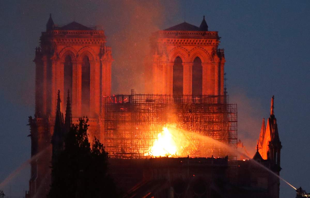 Firefighters douse flames of the burning Notre Dame Cathedral in Paris, France April 15, 2019.