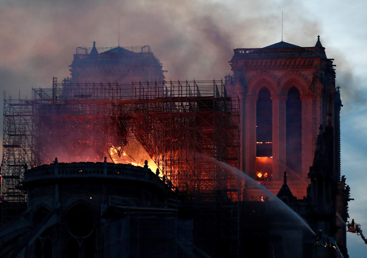 Firefighters douse flames of the burning Notre Dame Cathedral in Paris, France April 15, 2019.