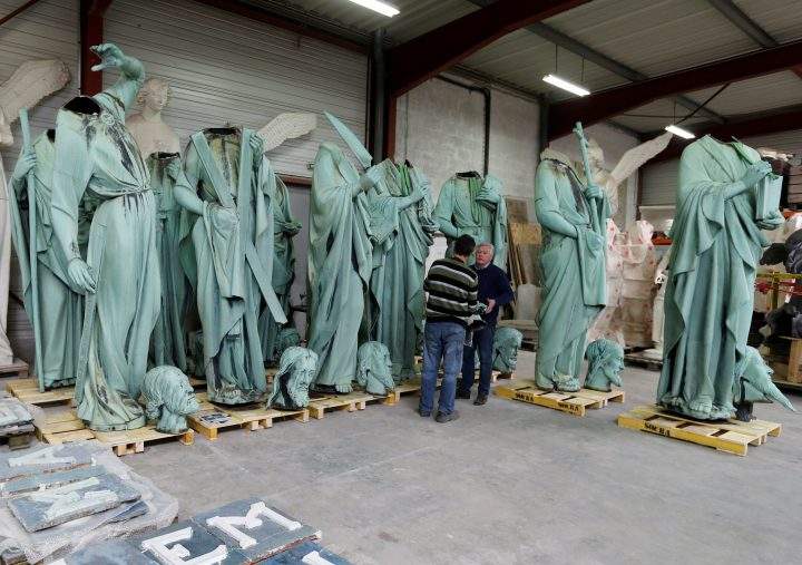 Consultant Patrick Palem checks statues that were removed from the spire of Paris’ Notre-Dame Cathedral in a workshop.