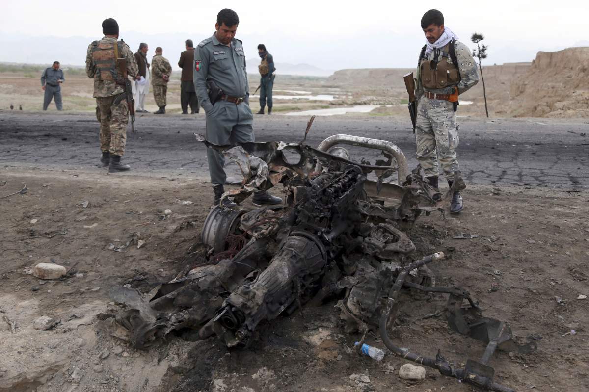 Afghan security forces gather at the site of Monday's suicide attack near the Bagram Air Base, north of Kabul, Afghanistan, Tuesday, April 9, 2019. 


