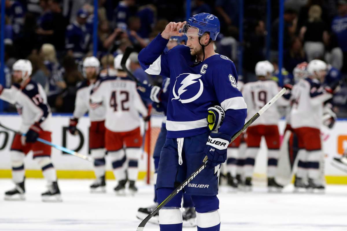 Tampa Bay Lightning center Steven Stamkos (91) skates off as the Columbus Blue Jackets celebrate their 4-3 win during Game 1 of an NHL Eastern Conference first-round hockey playoff series Wednesday, April 10, 2019, in Tampa, Fla. (AP Photo/Chris O’Meara)