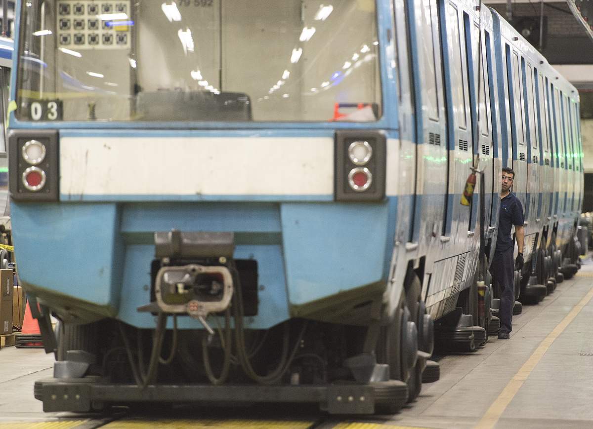 A Montreal Metro maintenance worker looks out from the door of a subway care at a garage during the early hours of the morning in Montreal, Thursday, April 11, 2019.