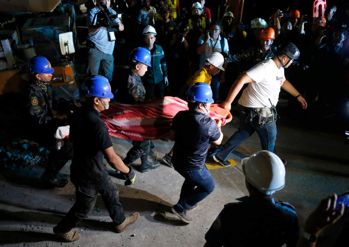 Rescuers carry a victim to a waiting ambulance after being pulled out from the rubble of a collapsed building following Monday’s magnitude 6.1 earthquake in Porac township, Pampangan province north of Manila, Philippines, Tuesday, April 23, 2019.