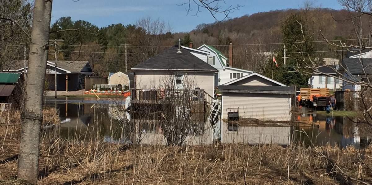 Rising water levels from the Gull River flood Anson Street in Minden, Ont., on Thursday.