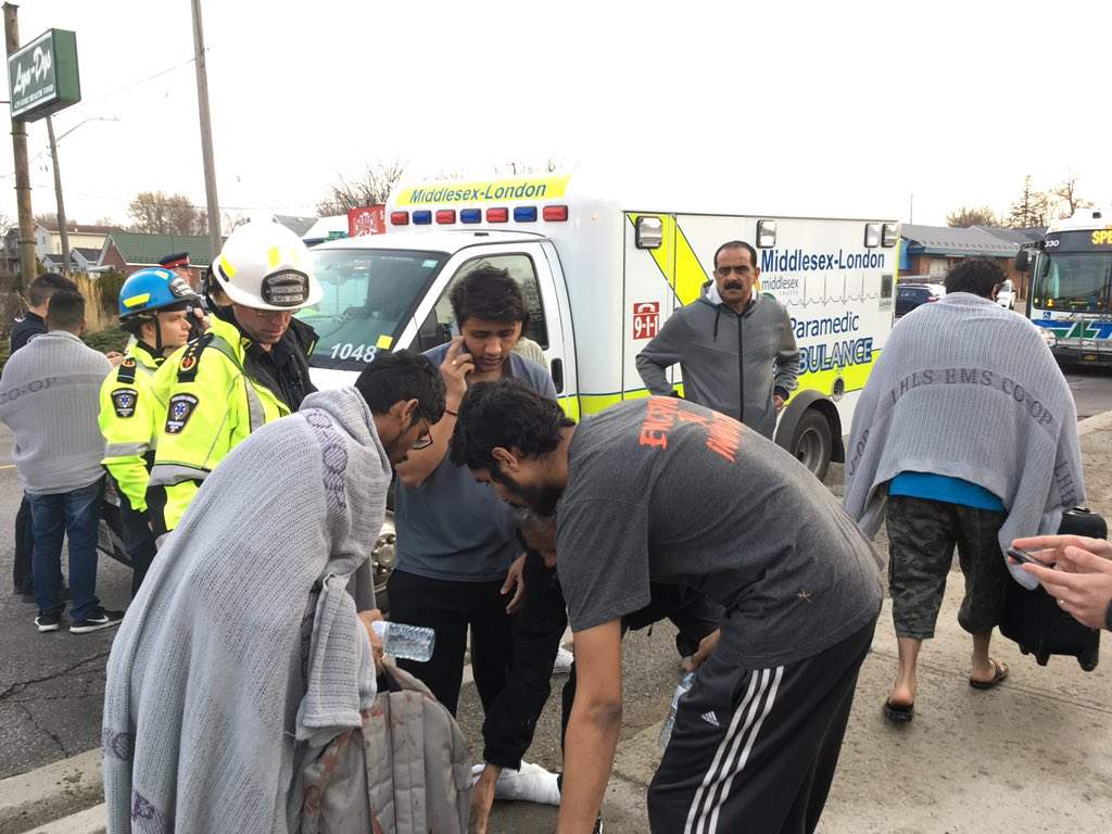 A group of young men who live in one of the building’s three units say they jumped through a window to escape the flames.