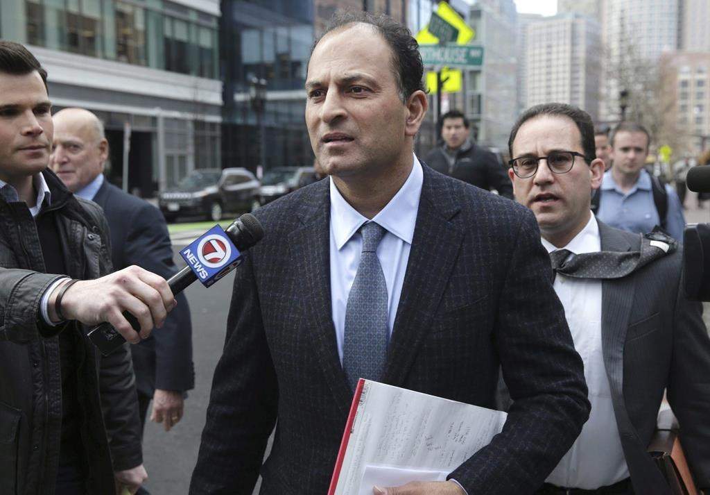 David Sidoo, of Vancouver, Canada, leaves following his federal court hearing Friday, March 15, 2019, in Boston. Sidoo faces an additional charge of conspiracy to commit money laundering for his alleged role in a college admissions scandal in the United States.