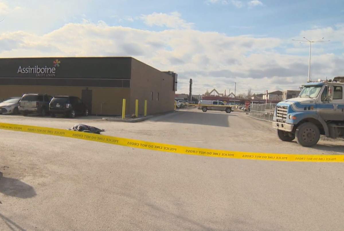 A tarp covers a body at Garden City Shopping Centre