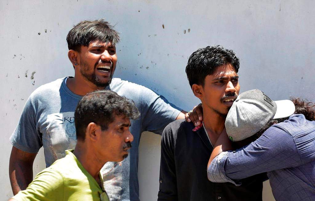 Relatives of a blast victim weep outside a police morgue in Colombo, Sri Lanka, Sunday, April 21, 2019. More than two hundred people were killed and hundreds more injured in eight blasts that rocked churches and hotels in and just outside Sri Lanka’s capital on Easter Sunday. (AP Photo/Eranga Jayawardena)