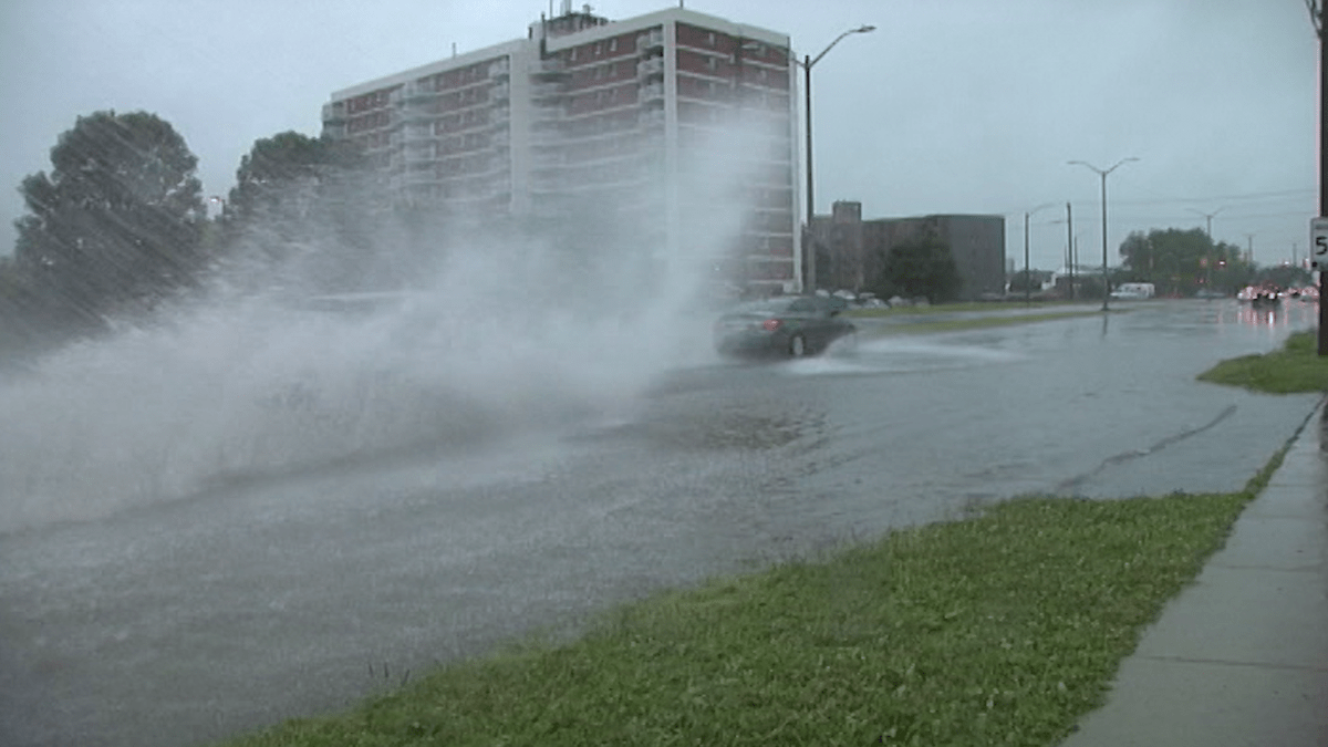 Cars drive through a flooded Bath Road in Kingston during the summer of 2017.