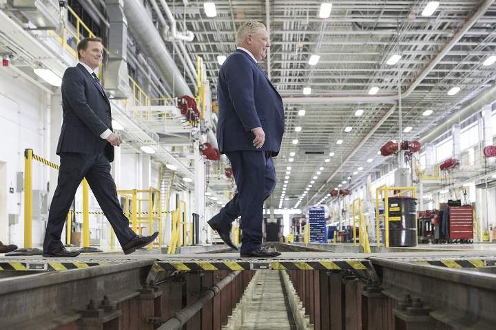 Ontario Premier Doug Ford, right, and Jeff Yurek, provincial Minister of Transportation, make their way to a photo opportunity ahead of an announcement about Ontario’s transit network, in Toronto on Wednesday, April, 10, 2019.