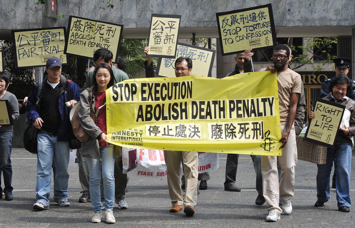 A group from human rights advocacy organization Amnesty International protesting the death penalty marches to the U.S. Consulate and Chinese Liaison office in Hong Kong on March 30, 2009.