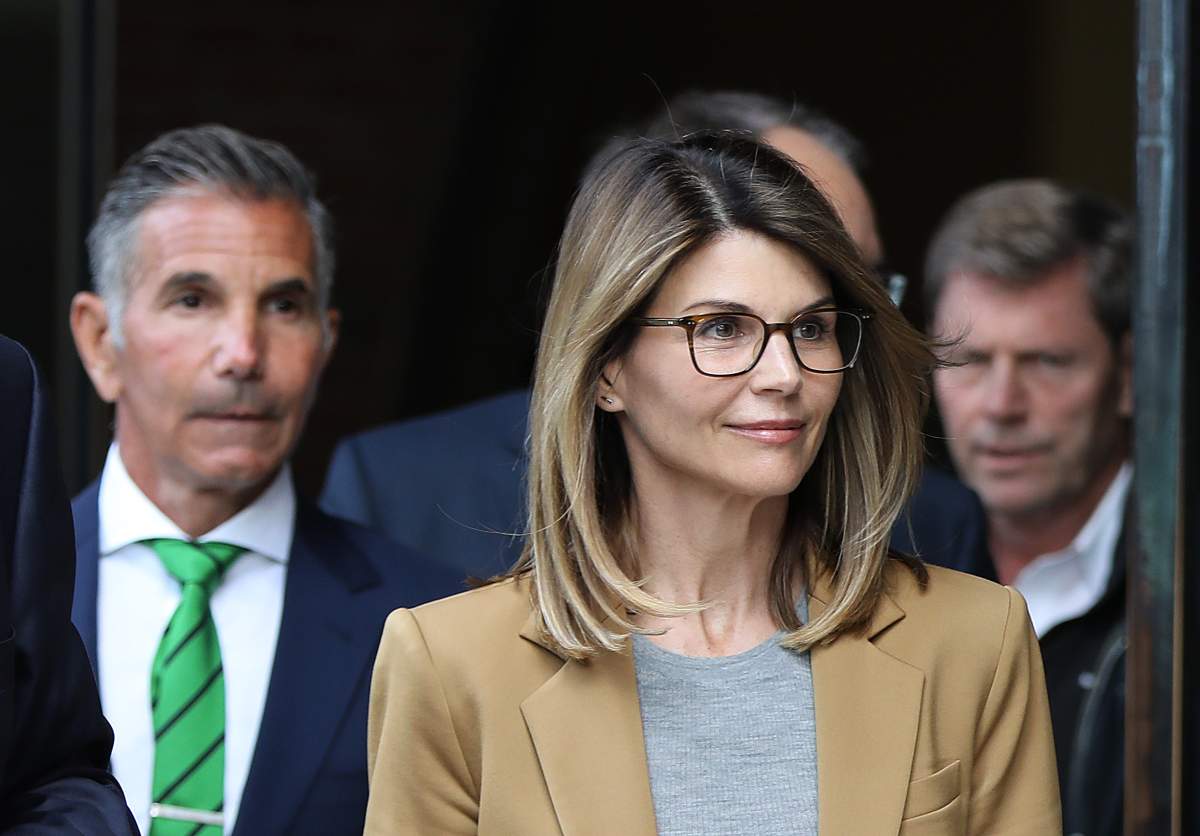 Actress Lori Loughlin and Mossimo Giannulli, wearing green tie at left, leave the John Joseph Moakley United States Courthouse in Boston on April 3, 2019.