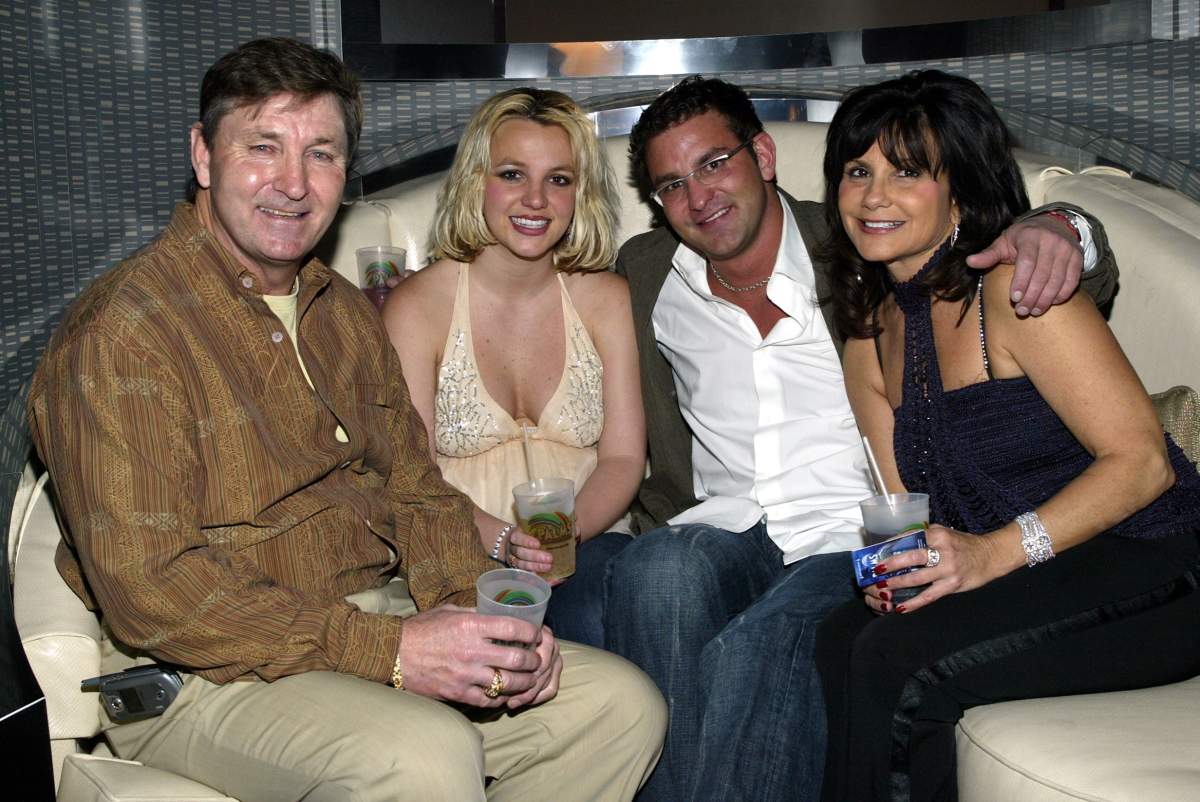 Britney Spears (2nd left) and family (L-R), father Jamie, brother Bryan and mother Lynne celebrate at the launch party for their new Palms Home Poker Host software at the Palms Casino Resort in Las Vegas, Nev.