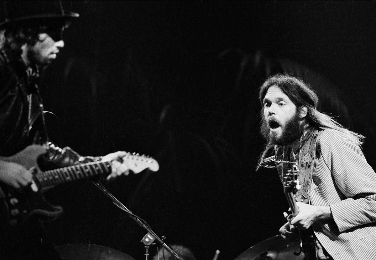 Nils Lofgren (left) and Neil Young performing with rock group Crazy Horse in England in November 1973.